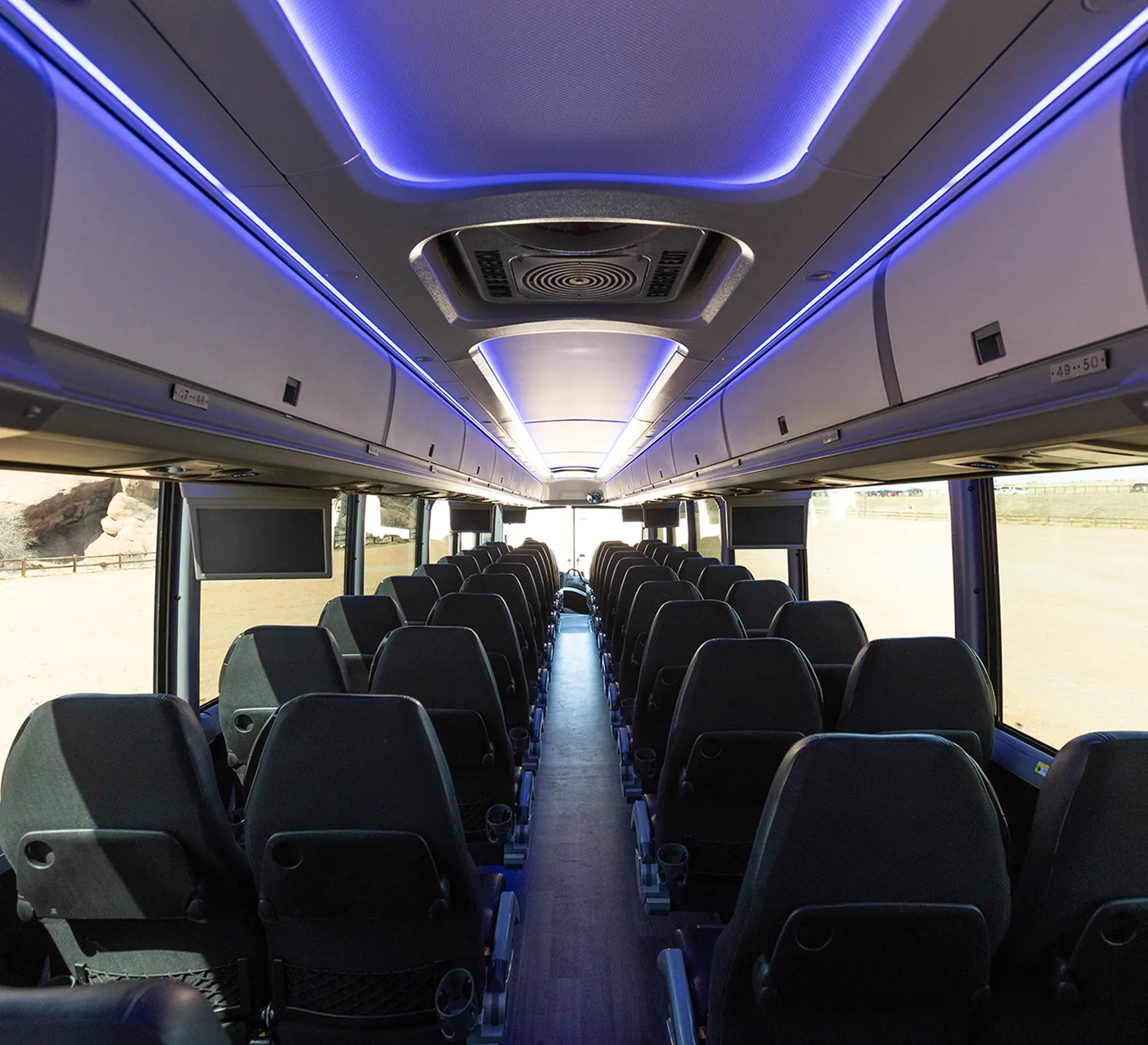 Interior of a luxury coach motorcoach with LED lighting and plush seating.