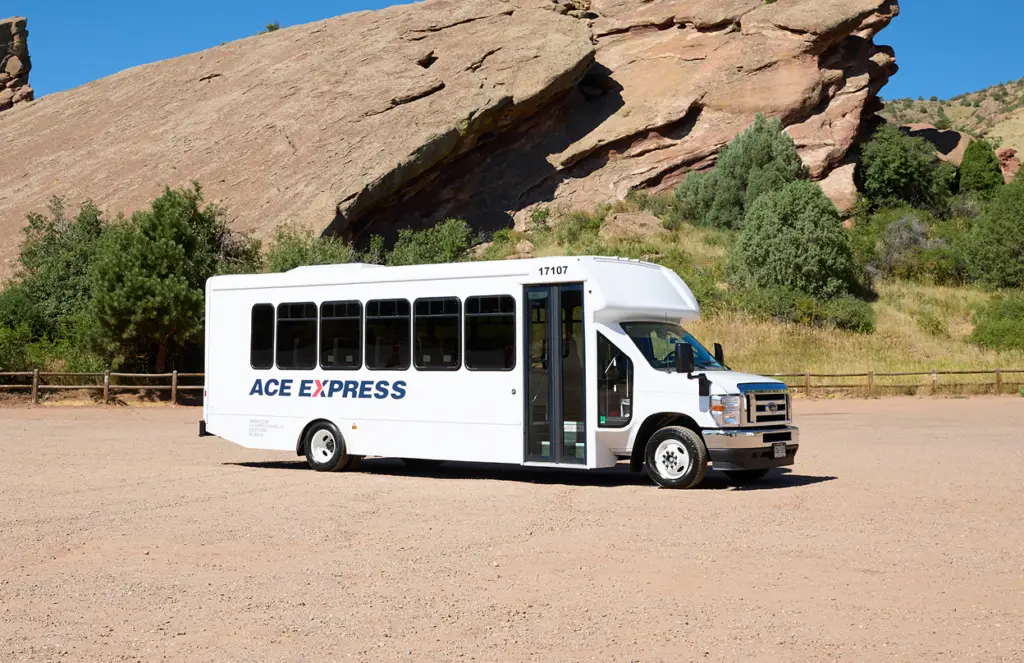 ACE EXPRESS shuttle motorcoach in scenic outdoor setting.