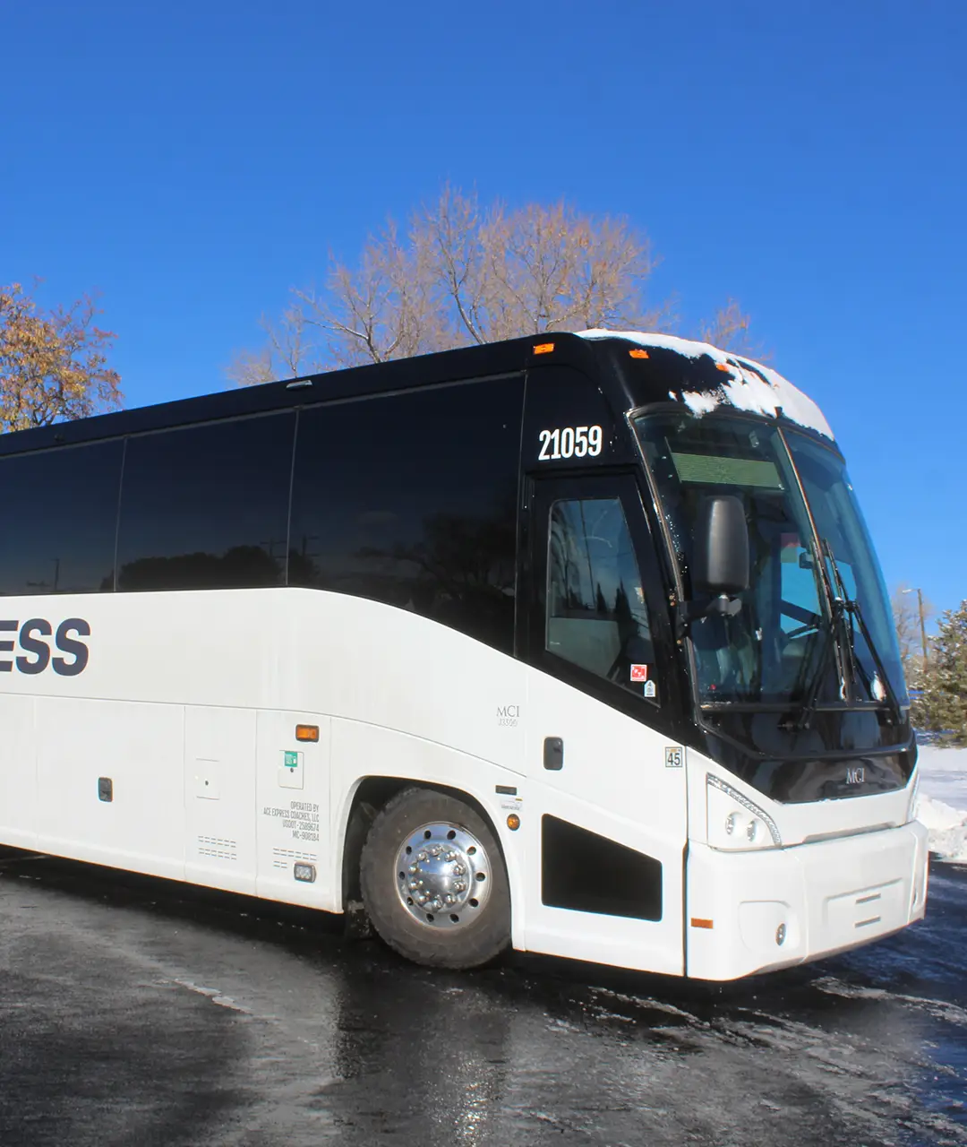 Motorcoach from Ace Express Coaches parked outdoors in winter.