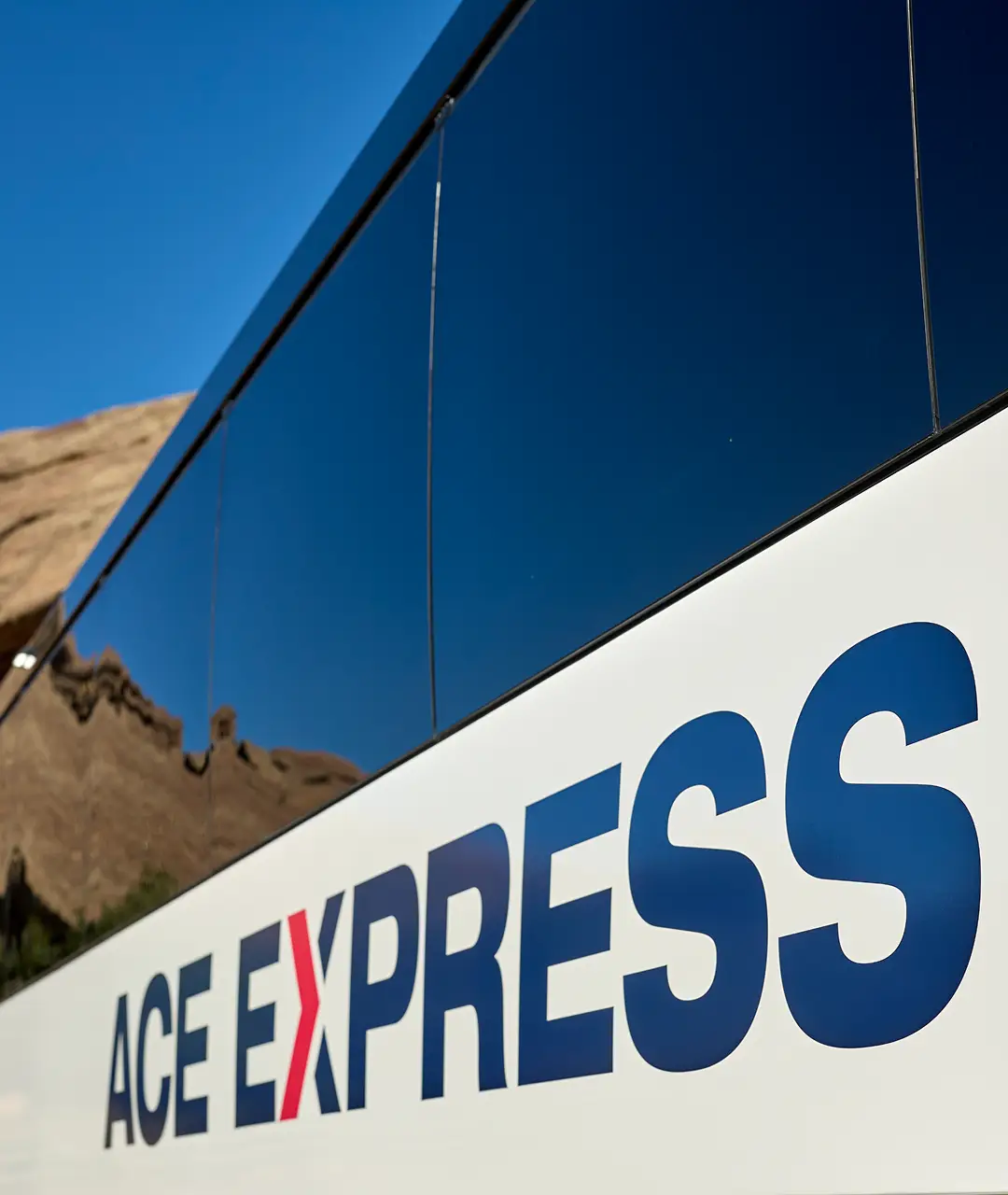 Ace Express Coaches motorcoach with company logo on side.