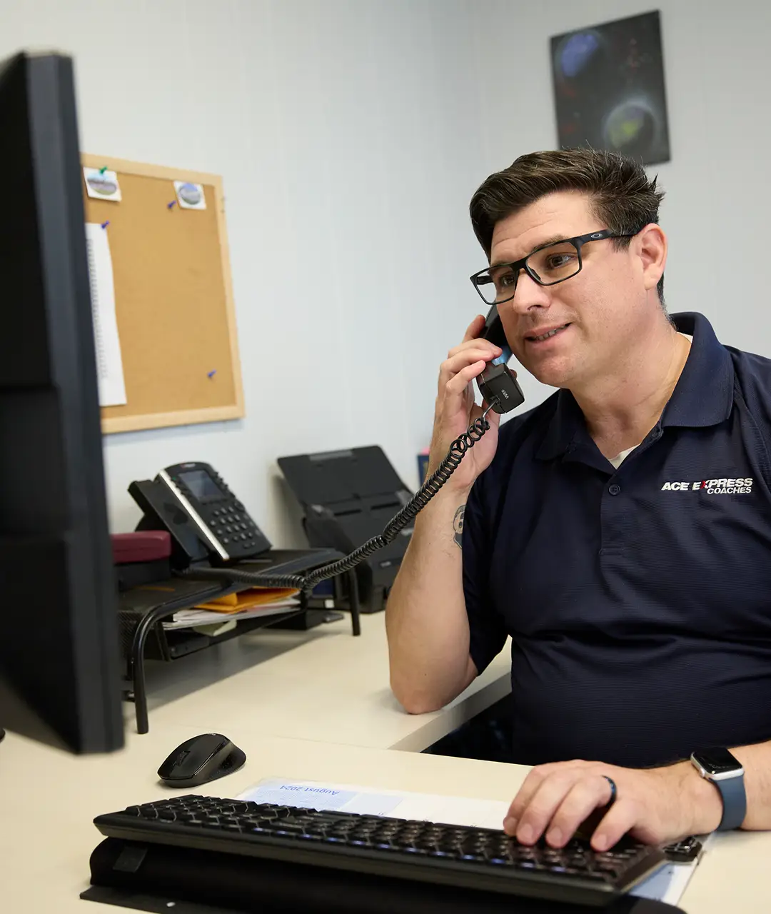 Customer service representative speaking on the phone at work in an office setting.